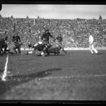 Football Iowa defenders tackling a U.S.C. back at the Coliseum in 1925