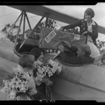 Young women and pilot with airplane and Easter lilies, Los Angeles, 1931