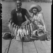 Actors Rod La Rocque and Vilma Banky with fish, Lake Arrowhead, 1929