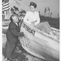 Lifeboat: Alfred Hitchcock standing and Tallulah Bankhead in lifeboat