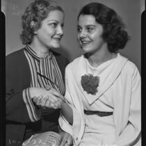 Young actresses Betty Burgess and Olympe Bradna shake hands, Los Angeles, 1935