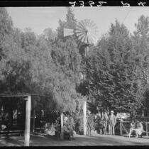 Eugene R. Plummer and group under windmill at his home, Hollywood, 1927