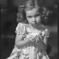 Sylvia Arslan holding toy elephant, 1937