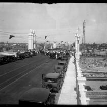 People and automobiles on Fourth St. Bridge during bridge's opening ceremony in 1931, Los Angeles, Calif.