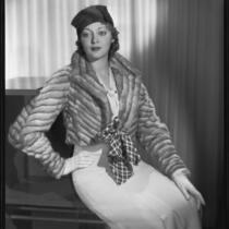Actress Kathleen Burke modeling fur jacket from Beckman's, 1933