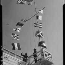 Actress Boots Mallory raising maritime signal flags at the Santa Monica Harbor Department, Santa Monica, 1937
