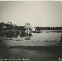 Man watering grass by Boat House at Westlake Park, MacArthur Park, Los Angeles