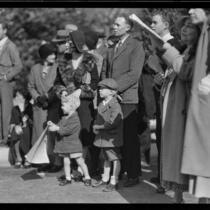 Family and other spectators at the Tournament of Roses Parade, Pasadena, 1932