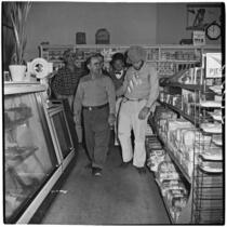 A. Anton and others in a convenience store during Anaheim's annual Halloween festival, Anaheim, October 31, 1946