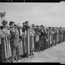 Spectators watching the Santa Anita Handicap race from behind a fence, Arcadia, 1936