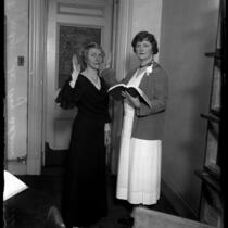 Judges May D. Lahey and Ida May Adams posed with right hands raised during Adam's oath of office in Los Angeles, Calif., 1931