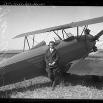 Pilot Jean Allen standing next to bi-plane in Los Angeles, Calif., circa 1923