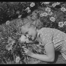 Santa Monica College student lying among flowers, Santa Monica, 1934