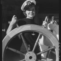 Actress Boots Mallory at a ship's wheel, Santa Monica, 1937