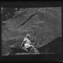 Carolyn Bartlett seated on rock, Yosemite National Park, 1941