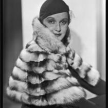 Actress Gail Patrick modeling a fur stole, circa 1932-1933