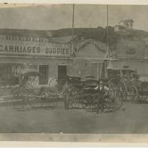 Men with carriages in front of Carriage and Buggy shop, Roeder S. Spring St., Los Angeles