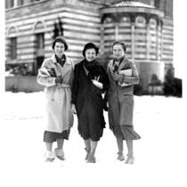 Snowfall on campus - Three female students standing in front of Education Building (Moore Hall), 1932