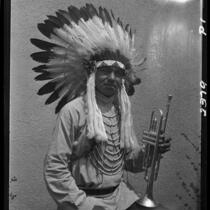 Young man in Indian regalia with trumpet, 1928