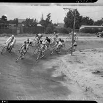 Cyclists practice on a dirt track for a six-day bicycle race at Pan-Pacific Auditorium, Los Angeles, 1937