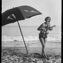 Woman on beach with ukulele, Long Beach, 1929