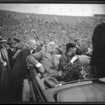 President Franklin D. Roosevelt, accompanied by Eleanor Roosevelt, about to address the crowd at Los Angeles Memorial Coliseum from car, October 1, 1935