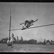 Elizabeth Stine, track athlete, engaged in high jump, circa 1922-1926