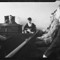 Zelda Smith on witness stand, with Coroner Frank Nance and jury, at arraignment of Harold Wolcott for the Pasadena murder of Helen Bendowski, 1933