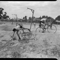 Cyclists practice on a dirt track during a six-day bicycle race at Pan-Pacific Auditorium, Los Angeles, 1937
