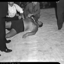 Wrestler Man Mountain Dean laying down in the ring at the Olympic Arena, Los Angeles, 1937