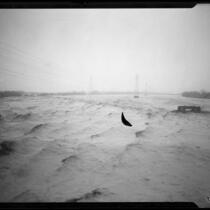 View of the Los Angeles River during rainstorm flooding, South Gate, 1927