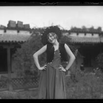 Dancer Evelyn Adams posing in a courtyard, circa 1920