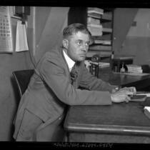 Private Investigator J. Frank Bisbee sitting at a desk in Los Angeles, Calif., circa 1924