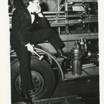 Man sitting on fire truck outside Palomar Ballroom, Los Angeles, October 2, 1939