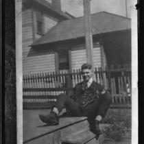 Actor Clark Gable as a young man, on porch with ukulele, [Ohio], [1920s?]