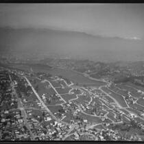 Aerial view of streets, hills, reservoir, and mountains, Los Angeles, [1930s?]