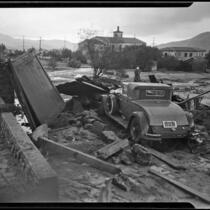Car surrounded by flood and mudslide debris behind the Holy Redeemer Church, La Crescenta-Montrose, 1934