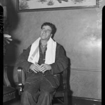 Confessed child-murderer Albert Dyer sitting in a chair with a towel around his neck, Inglewood, 1937