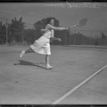 Catherine Rose, Tennis Champion on the Griffith Park tennis team, playing on a court, 1933