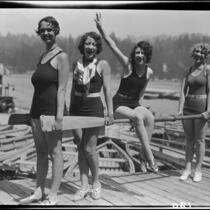 Young women with canoe paddles on dock, Lake Arrowhead, 1929