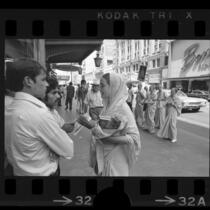 Hare Krishna members selling pamphlets in downtown Los Angeles, Calif., 1971