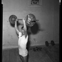Bantamweight boxer Frankie Campos lifting weights in Los Angeles, Calif., circa 1953