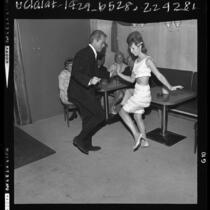 Man in suit and woman in fringed mini skirt, dancing the Go-Go at Sunset Strip nightclub in Los Angeles, Calif., 1964