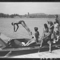 Young man diving from motorboat "Graceful," Lake Arrowhead, 1929