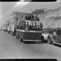 Trucks in the L.A.P.D. parade heading towards the Coliseum, Los Angeles, 1937
