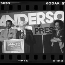 John B. Anderson at podium with Paul Winfield and Cecil Williams during presidential campaign in San Francisco, Calif., 1980