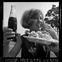 Young woman eating diet cola and french fries in Los Angeles, Calif., 1965