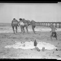 People at beach littered with trash in Los Angeles, Calif., circa 1949