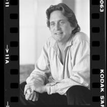 Actor and producer Michael Douglas, seated portrait, 1984