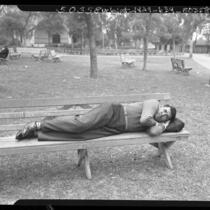 Joseph Raymond White-Eagle, disabled Indian war veteran, showing how he slept on park bench in Los Angeles, Calif., 1948